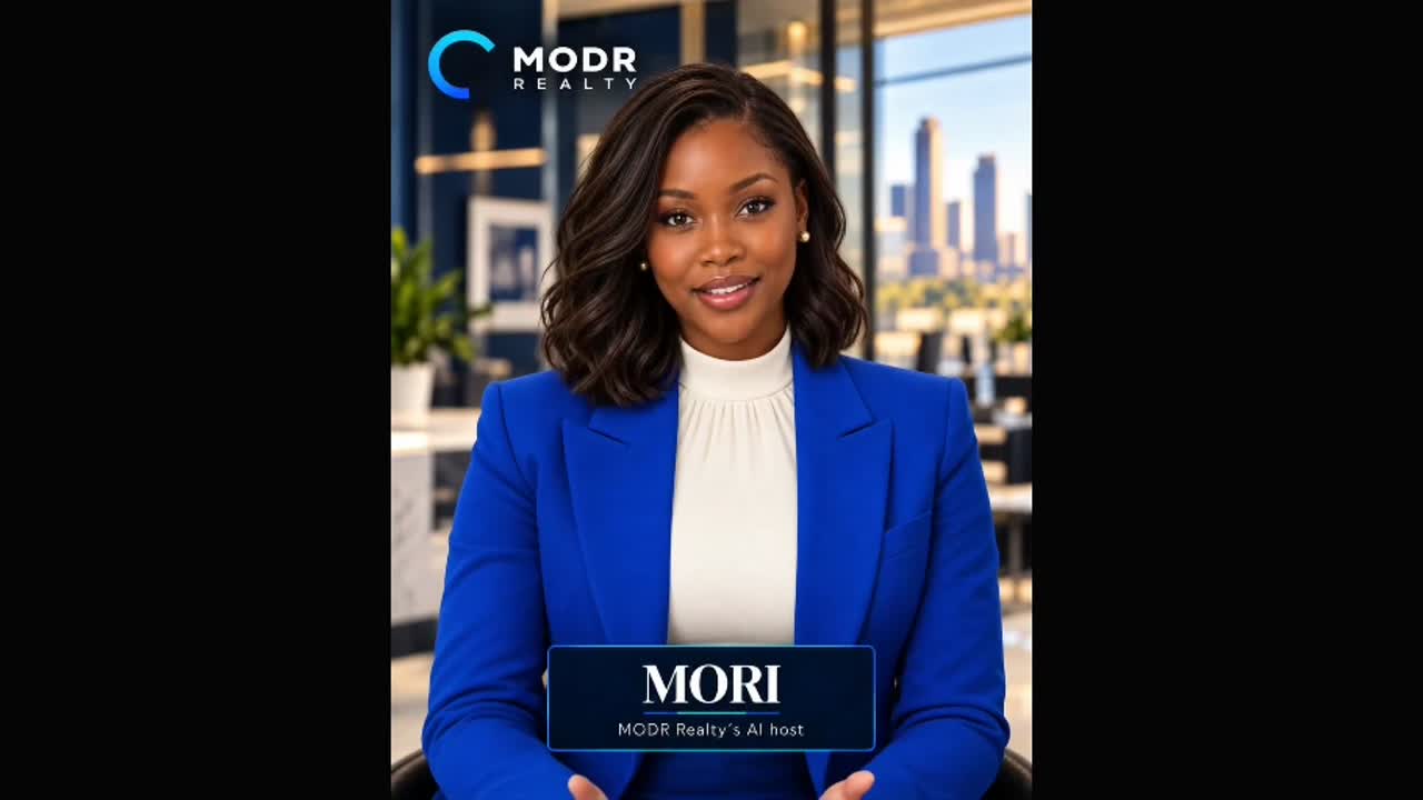 Mori, MODR Realty’s AI host, in a blue blazer at the MODR office